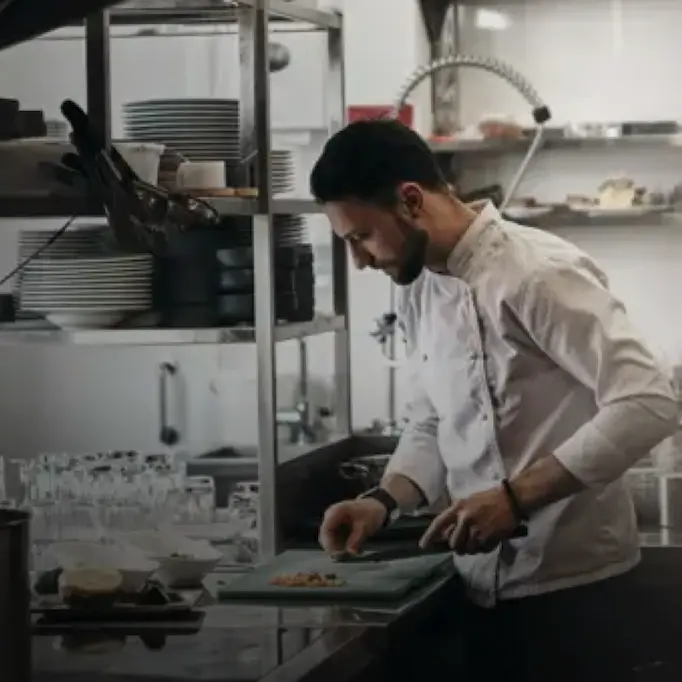 Chef in a professional kitchen in Egypt preparing food on a cutting board