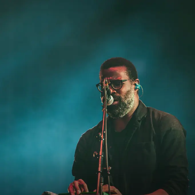 Musician performing in Morocco on stage with a microphone and keyboard.